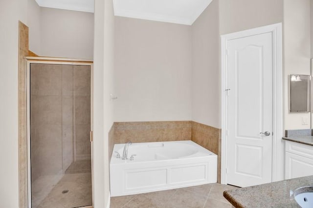 full bathroom featuring a garden tub, ornamental molding, a shower stall, tile patterned flooring, and vanity