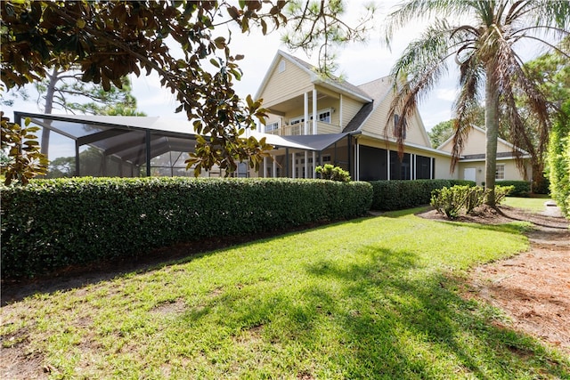 view of yard featuring a balcony and a sunroom