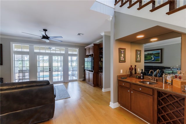 interior space with plenty of natural light, sink, french doors, and light hardwood / wood-style flooring