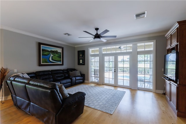 living room with french doors, ceiling fan, light wood-type flooring, and crown molding