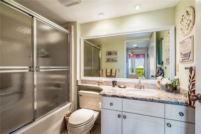 full bathroom featuring enclosed tub / shower combo, tile patterned floors, vanity, and toilet