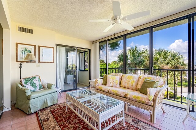 sunroom featuring ceiling fan