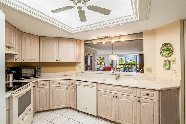 kitchen with sink, light tile patterned floors, light brown cabinets, white appliances, and premium range hood