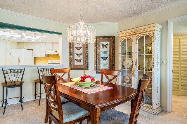 dining room with an inviting chandelier, a textured ceiling, light colored carpet, and ornamental molding