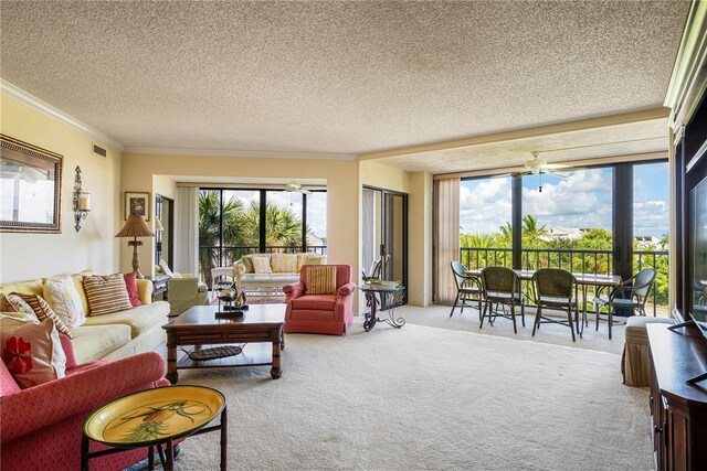 carpeted living room featuring a wealth of natural light, a textured ceiling, and crown molding