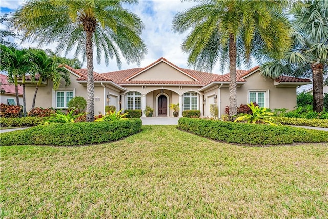 mediterranean / spanish home with a front yard