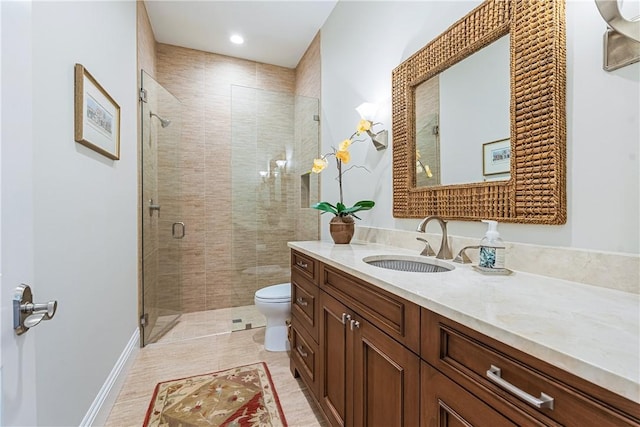 bathroom featuring vanity, an enclosed shower, and toilet