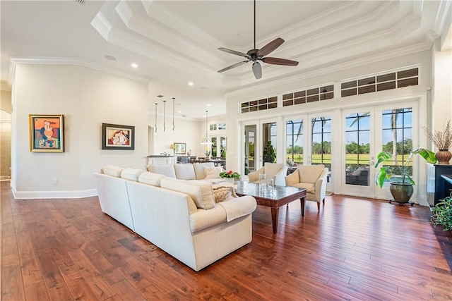 living room featuring crown molding, ceiling fan, french doors, dark hardwood / wood-style flooring, and a raised ceiling