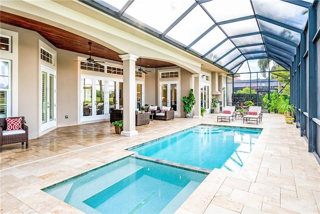 view of swimming pool featuring french doors, a lanai, ceiling fan, an outdoor living space, and a patio area