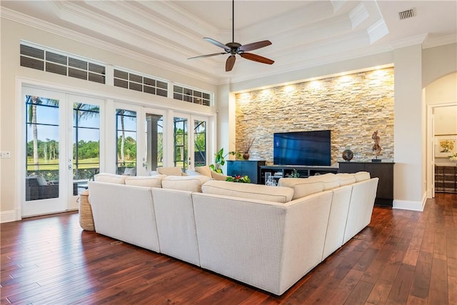 living room with crown molding, ceiling fan, a tray ceiling, and dark hardwood / wood-style floors