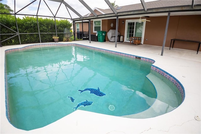 view of pool with a grill, a patio area, ceiling fan, and glass enclosure