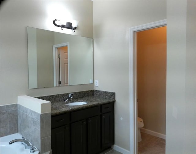 full bathroom with baseboards, toilet, a garden tub, tile patterned flooring, and vanity