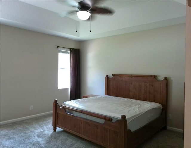 bedroom with a ceiling fan, carpet flooring, and baseboards