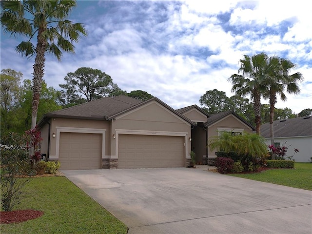 ranch-style home featuring a garage, a front yard, concrete driveway, and stucco siding