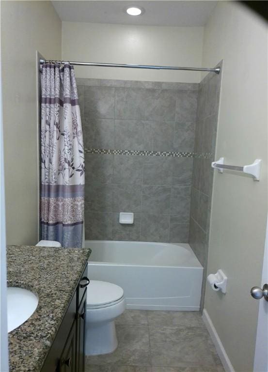 bathroom with shower / bathtub combination with curtain, toilet, vanity, baseboards, and tile patterned floors