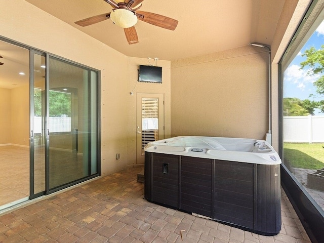 sunroom with a jacuzzi and ceiling fan