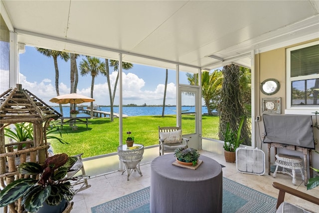 sunroom / solarium with a healthy amount of sunlight and a water view