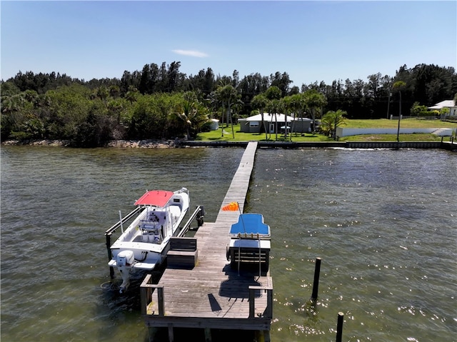 dock area featuring a lawn and a water view