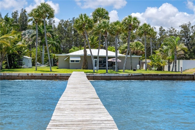 view of dock featuring a yard and a water view