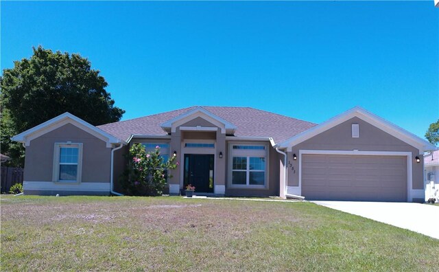 ranch-style house featuring a front yard and a garage