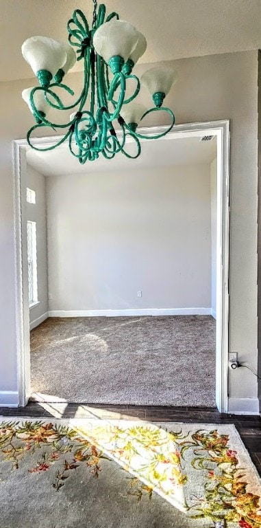 unfurnished dining area featuring dark colored carpet