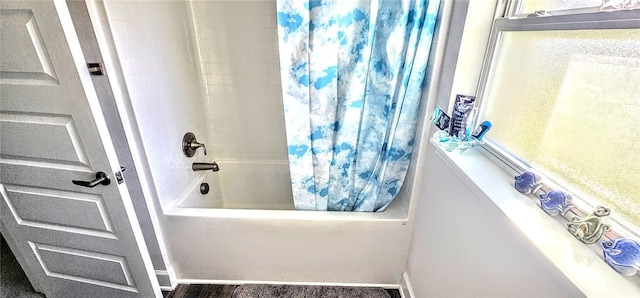 bathroom with shower / bathtub combination with curtain