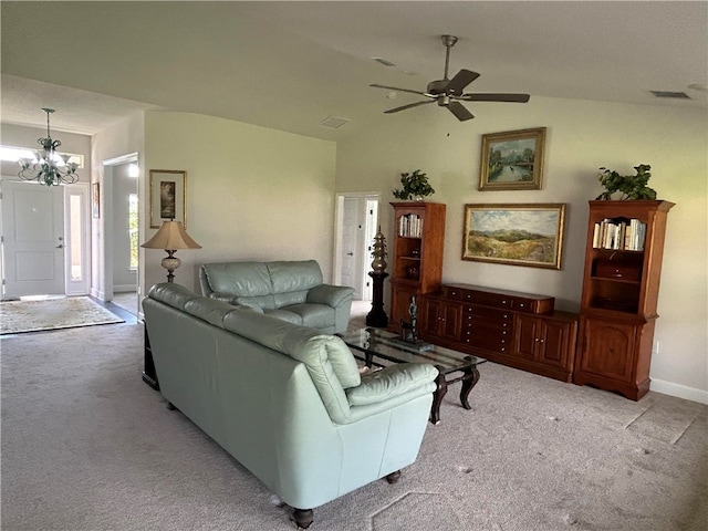 carpeted living room with ceiling fan with notable chandelier and lofted ceiling