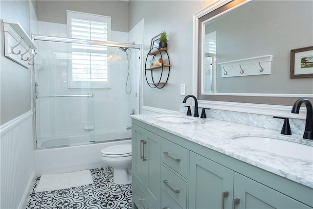 500 45th Ct SW, Vero Beach, FL 32968 - bathroom featuring double vanity, combined bath / shower with glass door, and tile patterned floors