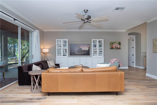 500 45th Ct SW, Vero Beach, FL 32968 - living room with light wood-style flooring, arched walkways, ceiling fan, and ornamental molding
