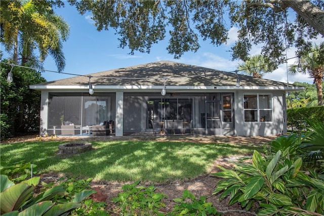 500 45th Ct SW, Vero Beach, FL 32968 - rear view of house with a sunroom, a yard, and a fire pit