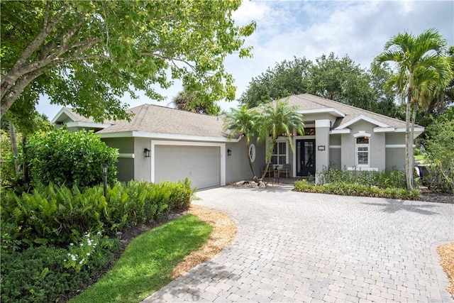 500 45th Ct SW, Vero Beach, FL 32968 - single story home with stucco siding, decorative driveway, a garage, and roof with shingles