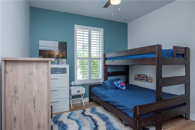 500 45th Ct SW, Vero Beach, FL 32968 - bedroom with wood finished floors, ceiling fan, and a textured ceiling