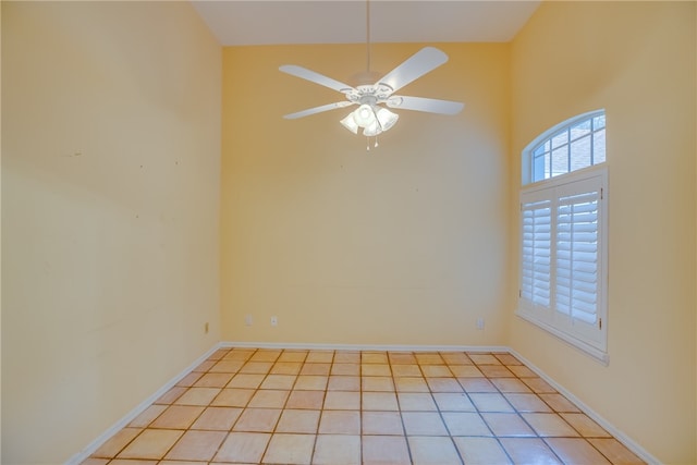 unfurnished room featuring light tile patterned floors, a high ceiling, and ceiling fan