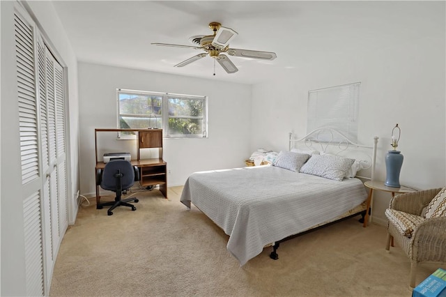 carpeted bedroom featuring a closet and ceiling fan