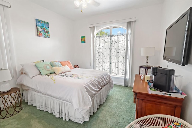 bedroom with ceiling fan, carpet flooring, and multiple windows