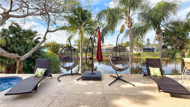 surrounding community featuring a water view and a patio