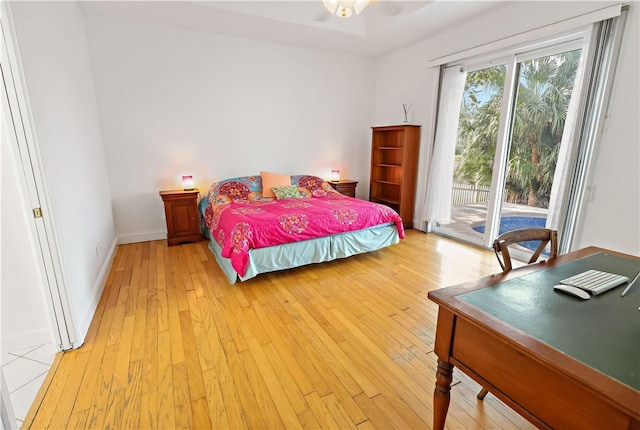 bedroom featuring light hardwood / wood-style flooring and access to outside