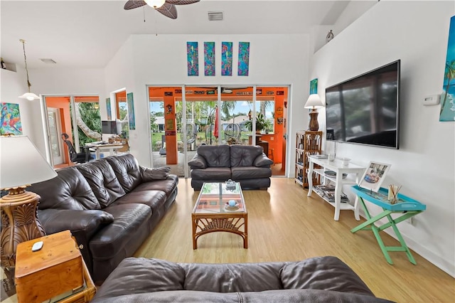 living room featuring ceiling fan and light wood-type flooring