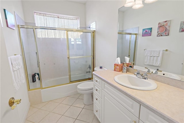 full bathroom featuring bath / shower combo with glass door, toilet, tile patterned floors, and vanity