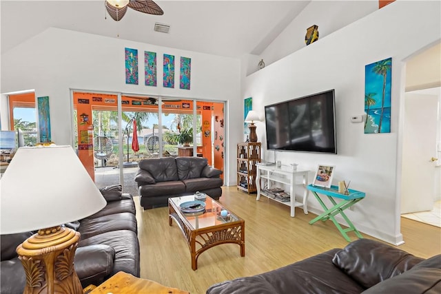 living room with hardwood / wood-style flooring, high vaulted ceiling, and ceiling fan