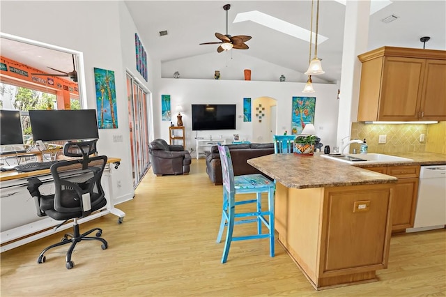 kitchen with sink, ceiling fan, backsplash, white dishwasher, and light wood-type flooring