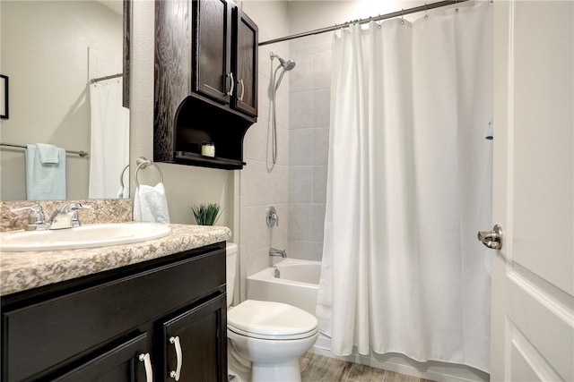 full bathroom featuring hardwood / wood-style floors, vanity, shower / bath combination with curtain, and toilet