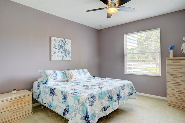 bedroom with ceiling fan and light colored carpet