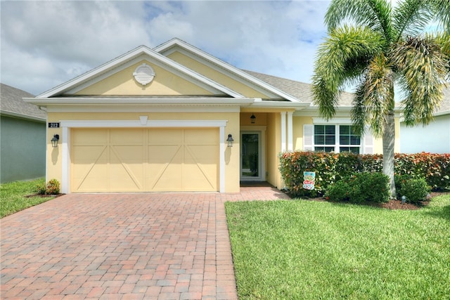 view of front of property featuring a garage and a front lawn