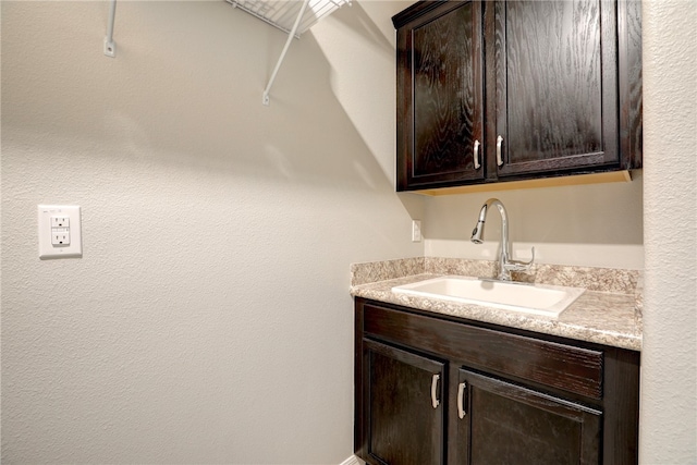 clothes washing area with sink