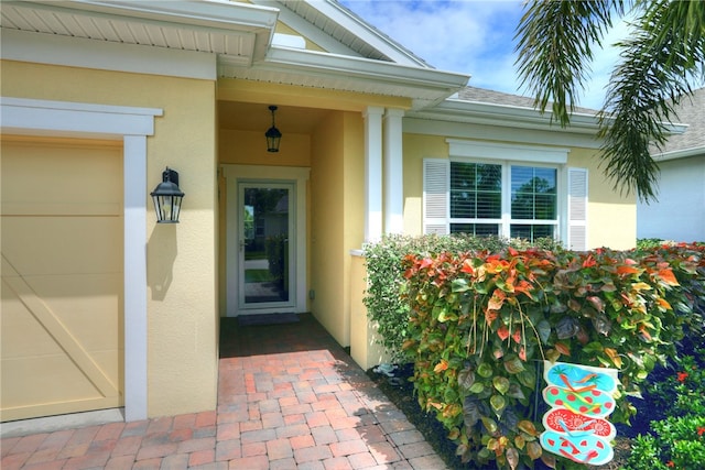 view of exterior entry with a garage