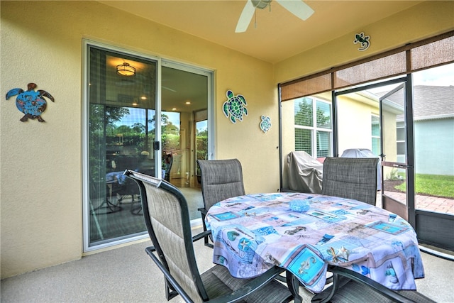 sunroom / solarium featuring plenty of natural light and ceiling fan