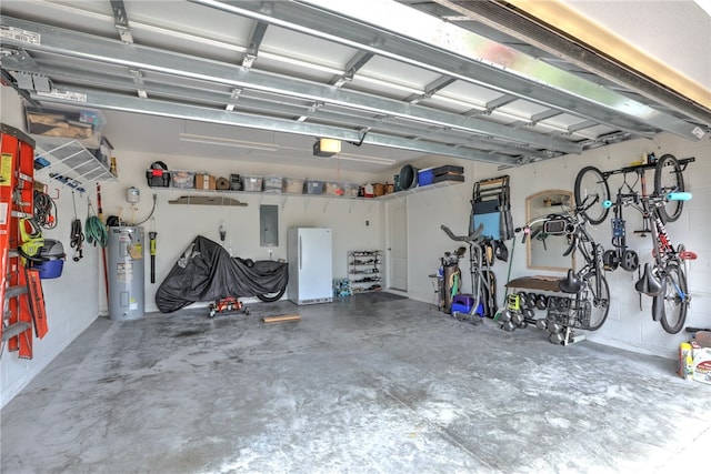 garage with electric panel, a garage door opener, water heater, and white refrigerator