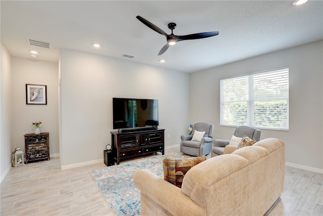 living room with light wood-type flooring and ceiling fan