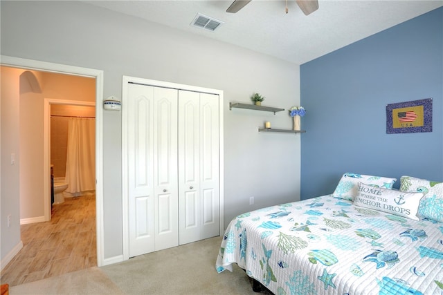 carpeted bedroom with ceiling fan and a closet